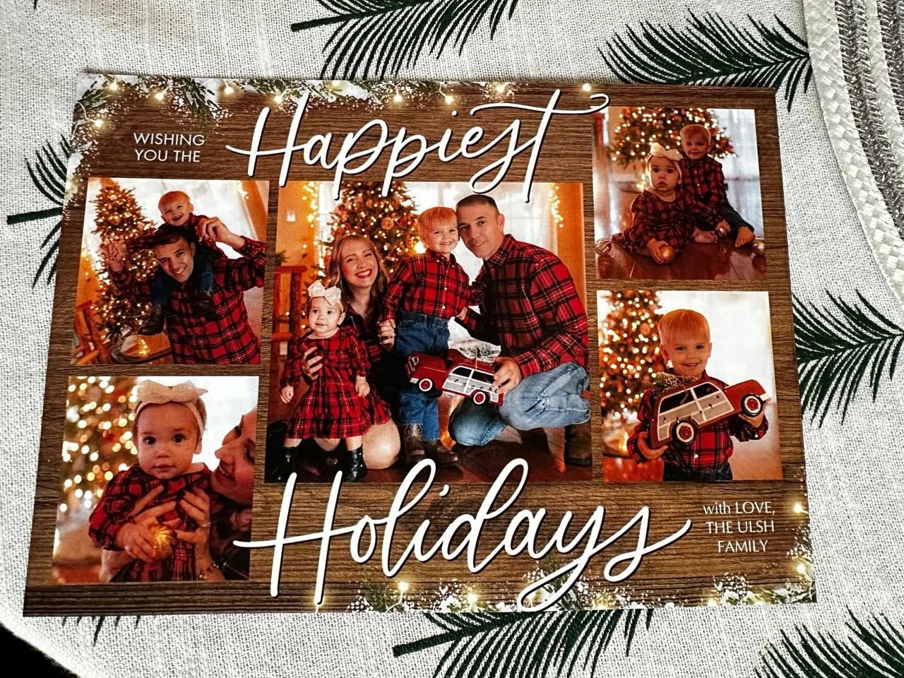 Holiday greeting card layout with string of festive family photos and 'Happiest Holidays' text over palm leaf background.