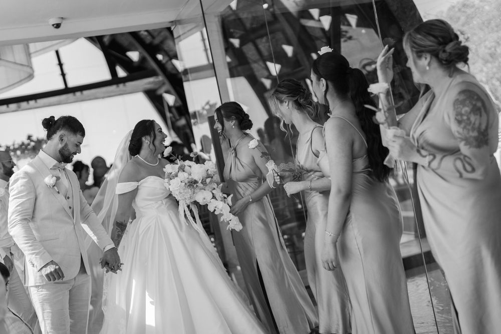Wedding party getting ready in matching robes during pre-ceremony preparations.