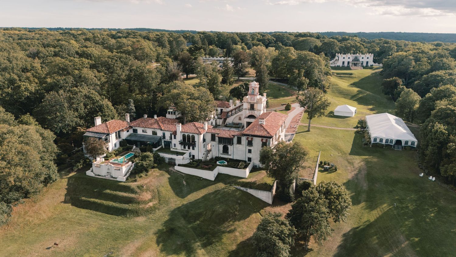 Aerial view of Vanderbilt Museum
sprawling historic estate mansion surrounded by lush woodland grounds.