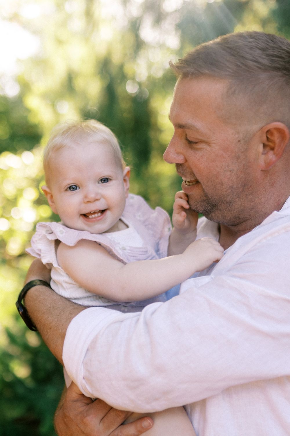Candid outdoor family photos showing joyful moments in sunlit natural setting.