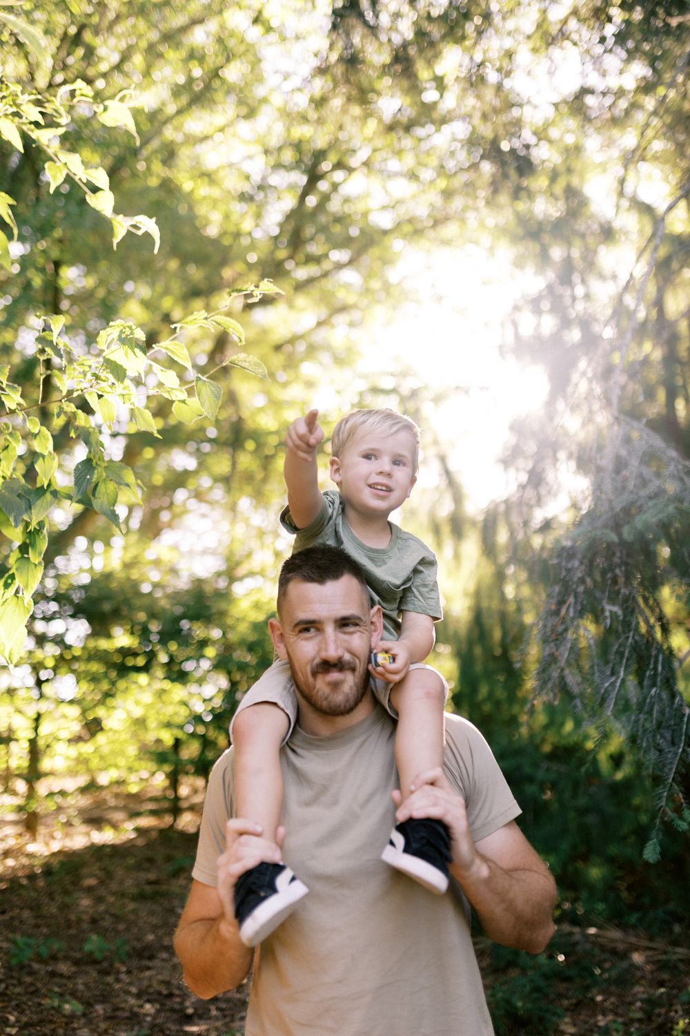 A series of candid outdoor family photos showing playful moments between a parent and child in sunlit woods.