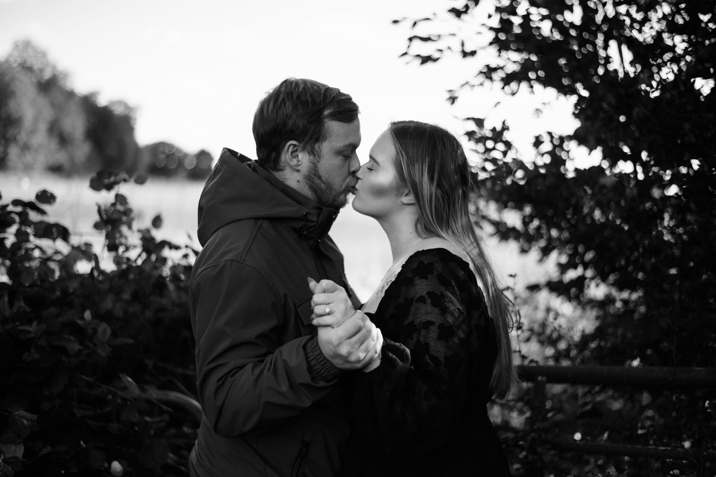 A romantic black and white portrait of a couple during an intimate moment.