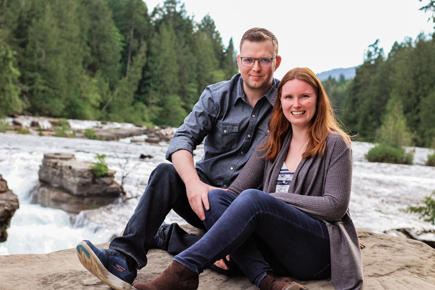 Couple sitting near river in Comox