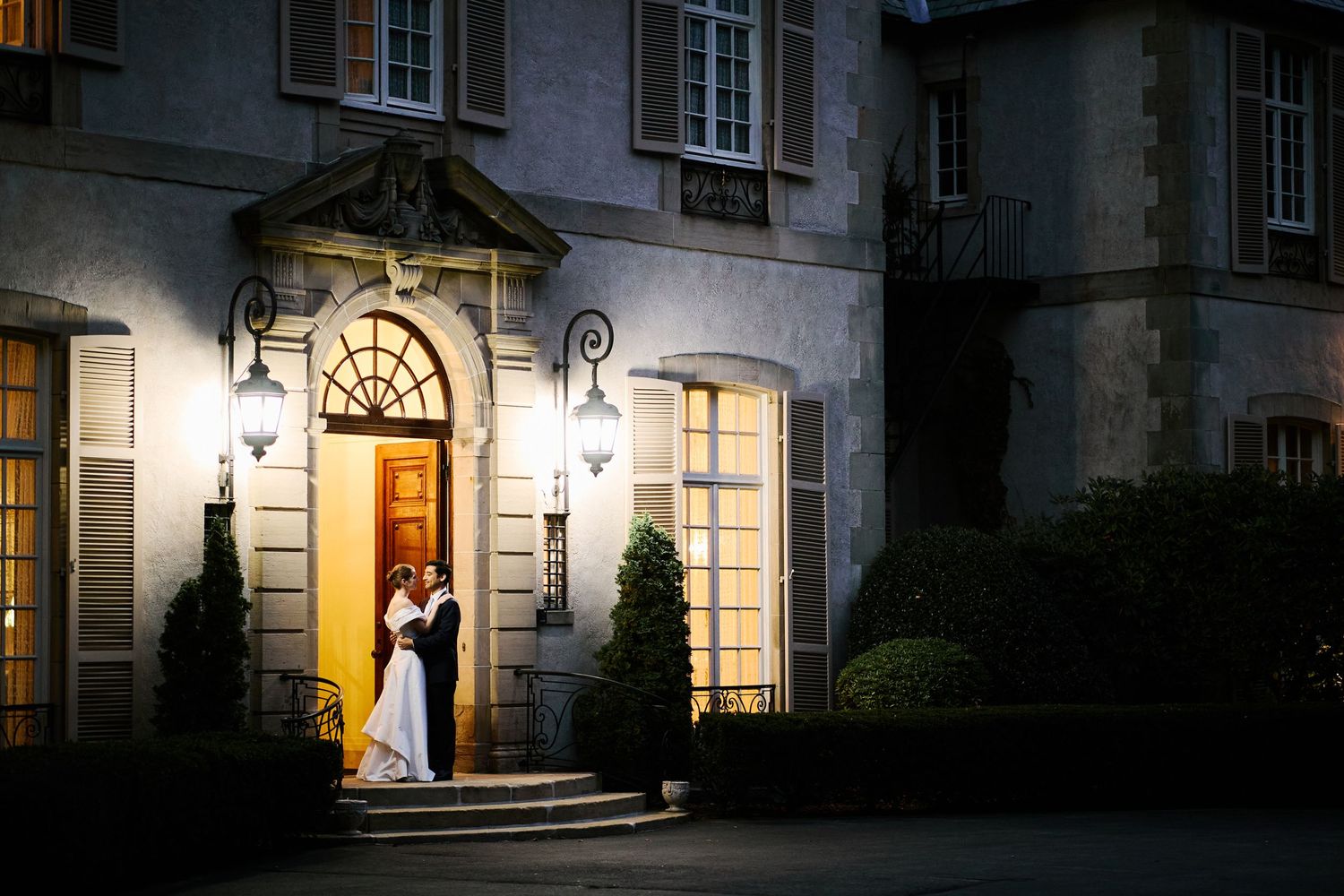 Dramatic nighttime architectural shot of illuminated building entrance.