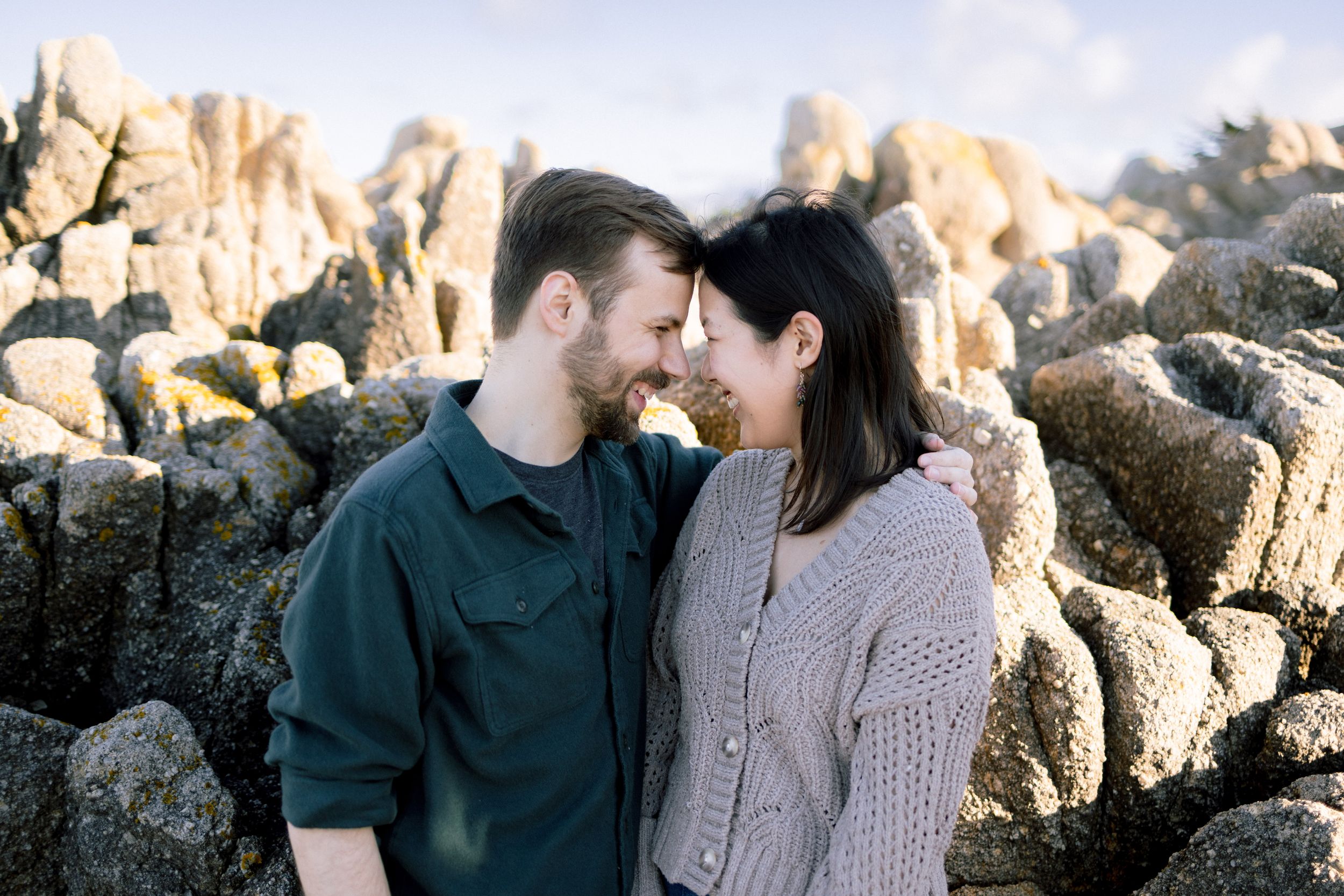 Monterey Bay engagement portraits along rocky coastline
