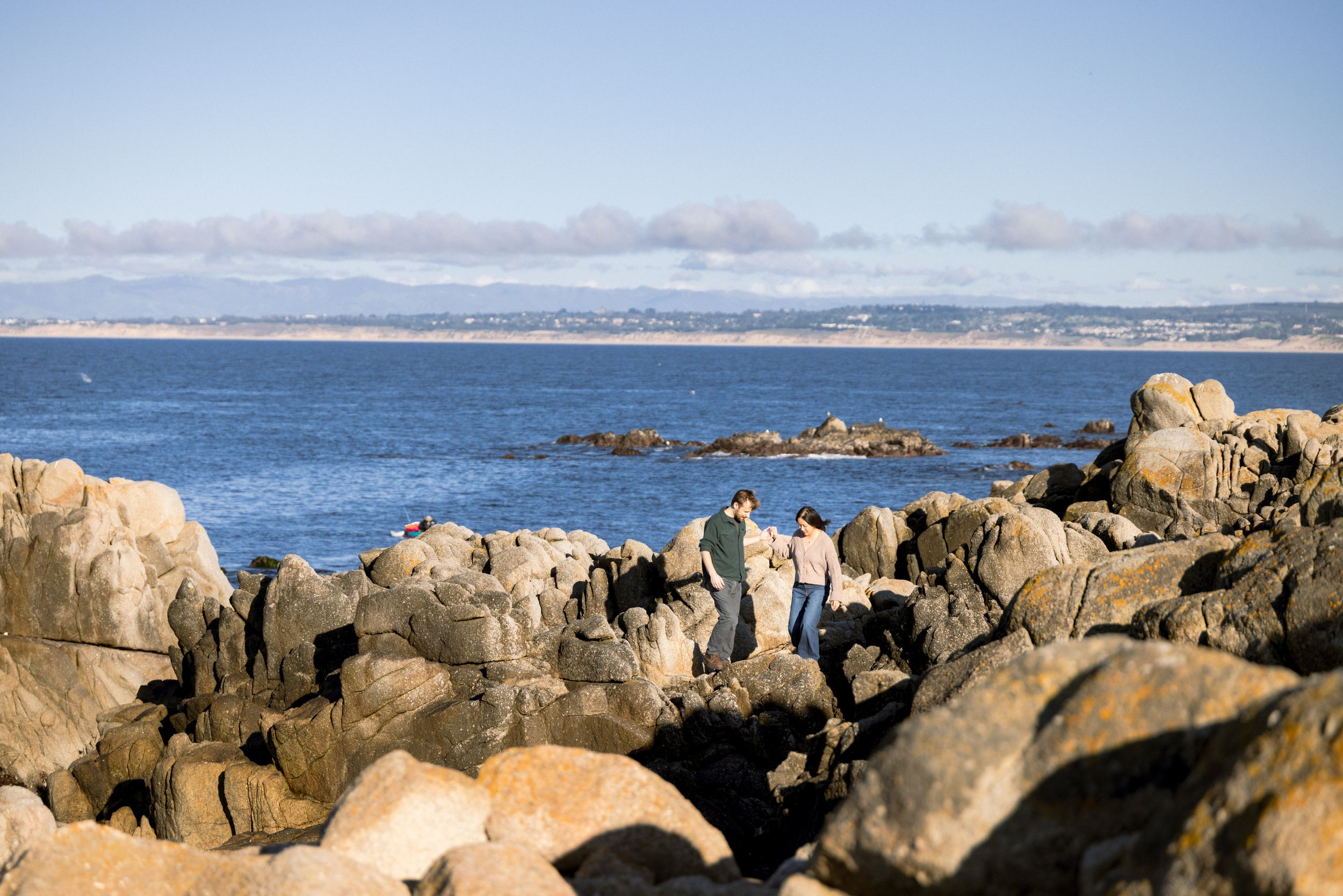 Monterey Bay engagement portraits along rocky coastline
