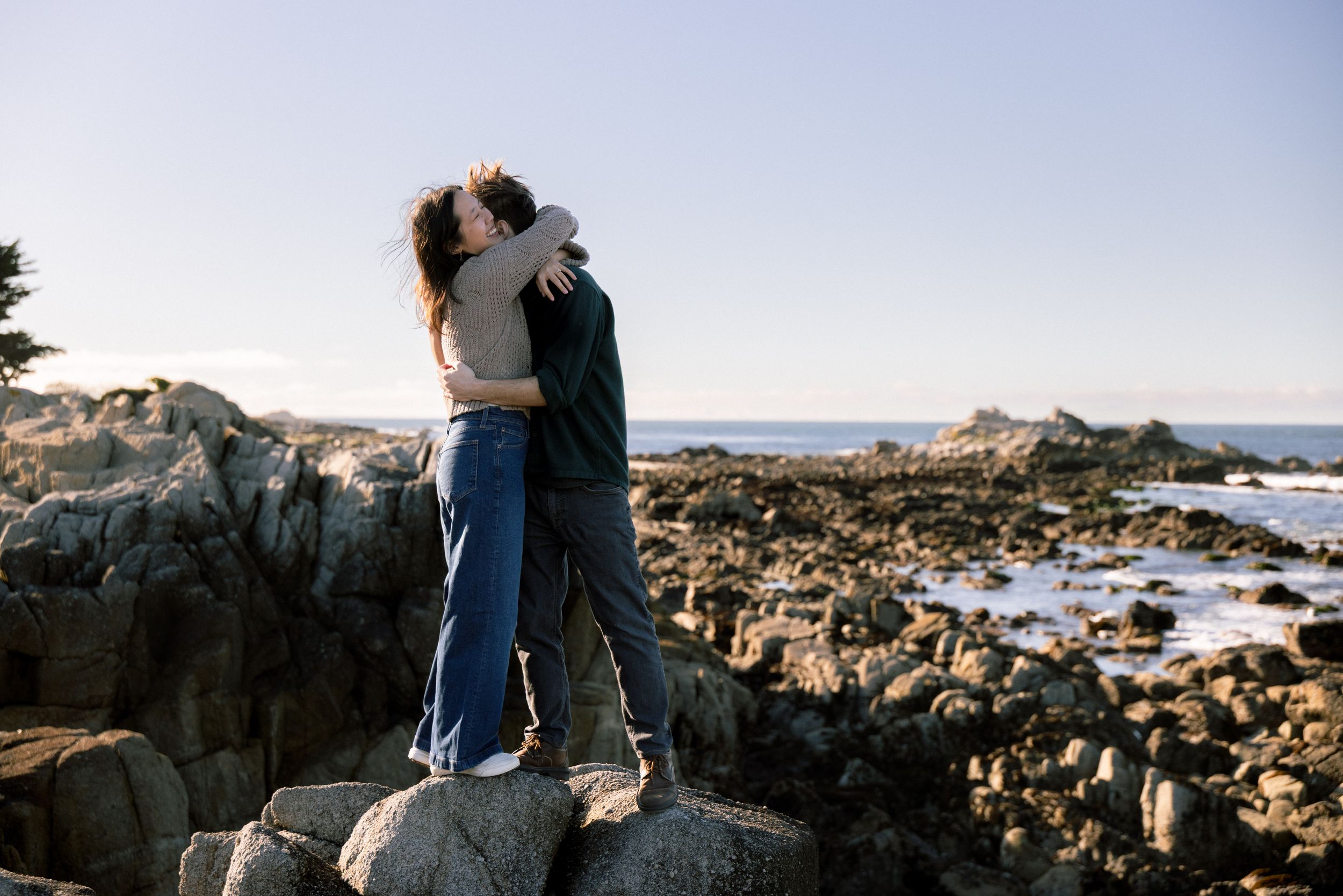 Monterey Bay engagement portraits along rocky coastline