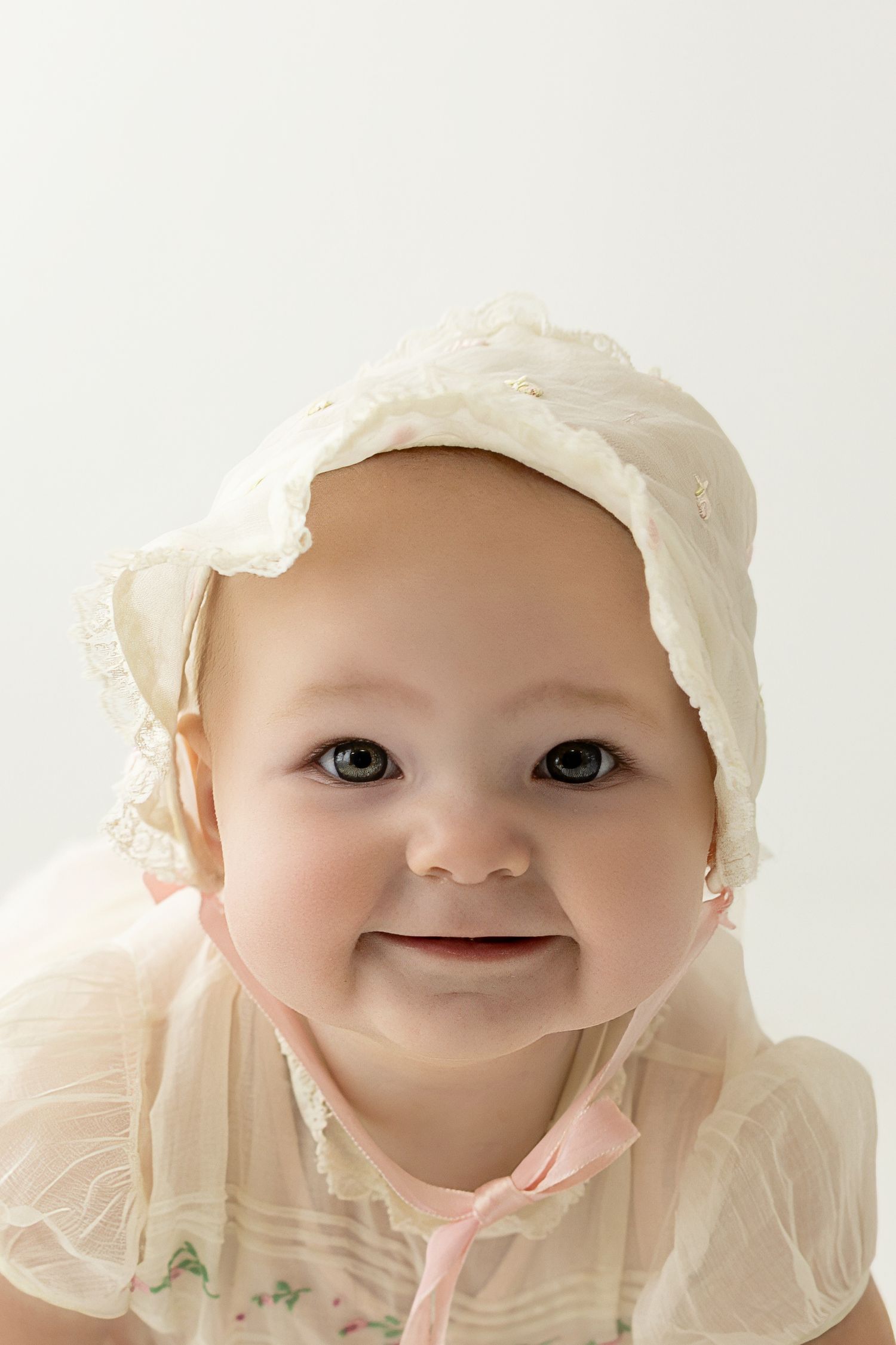 Baby girl smiling in white bonnet – Maria Chao Photography newborn photographer - Sacramento Photographer