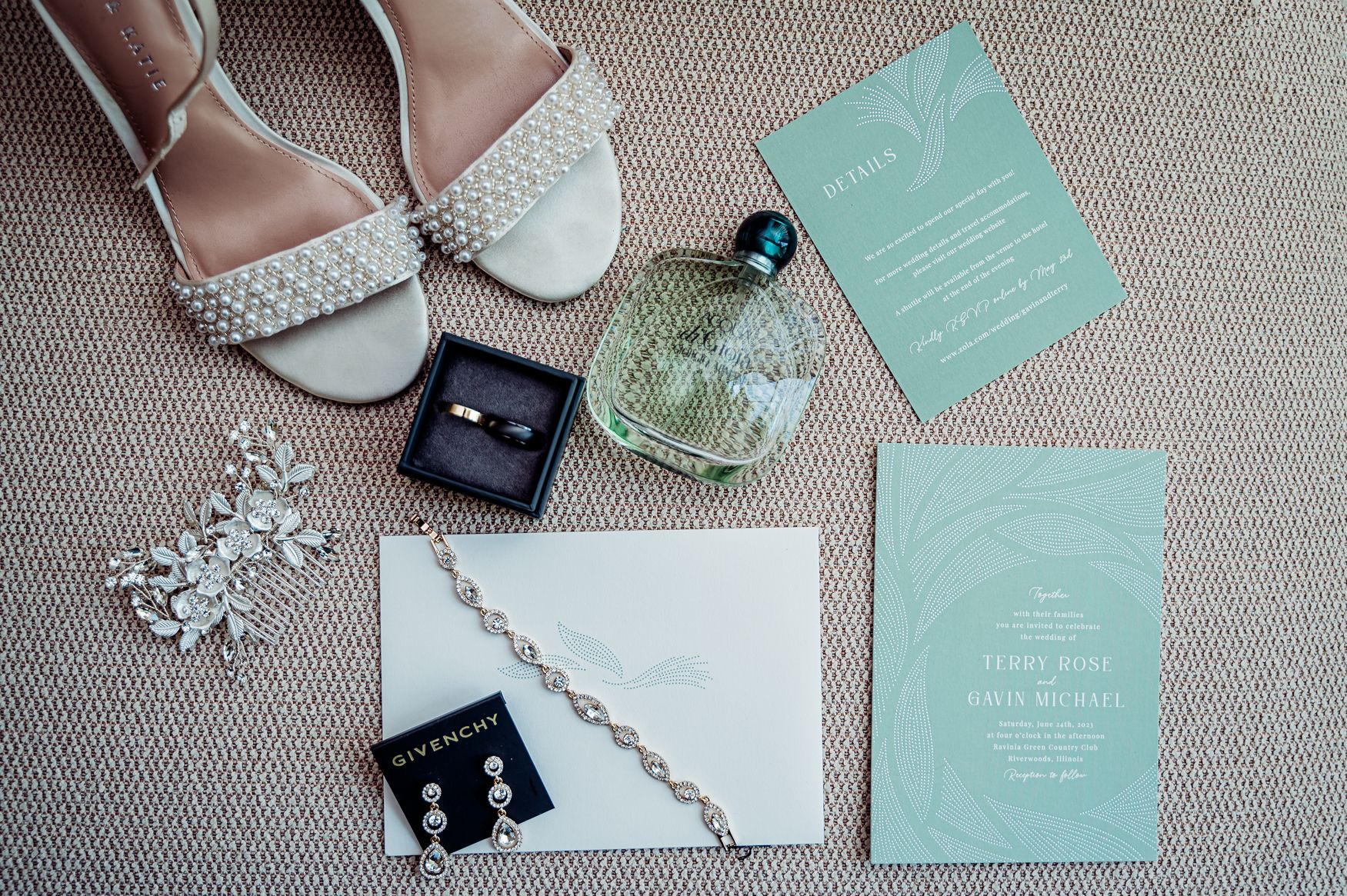 Elegant wedding flat lay featuring bridal shoes, ring box, perfume, earrings, bracelet, and mint green invitations on neutral background.