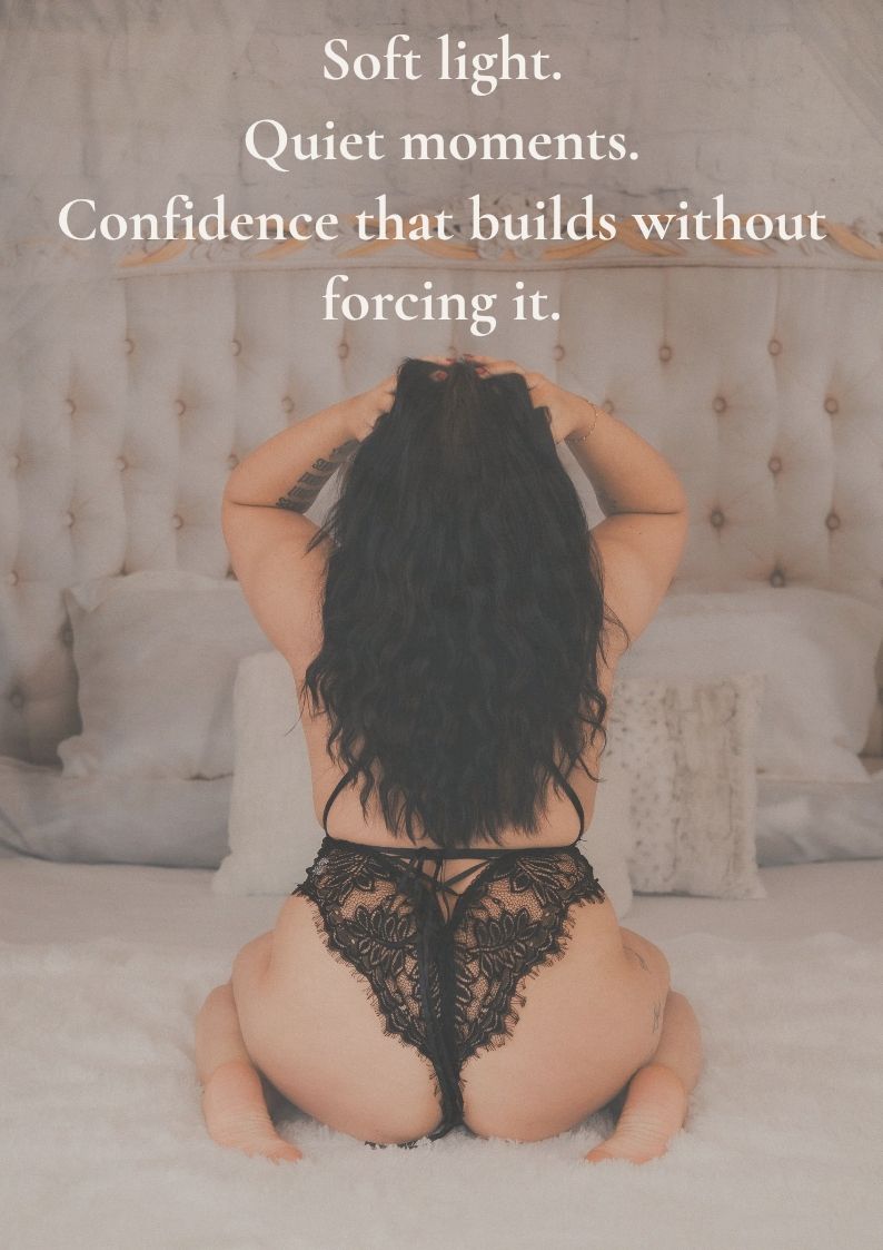 Woman in black lace lingerie sitting on a bed, promoting boudoir photography with soft light and confidence-building moments.