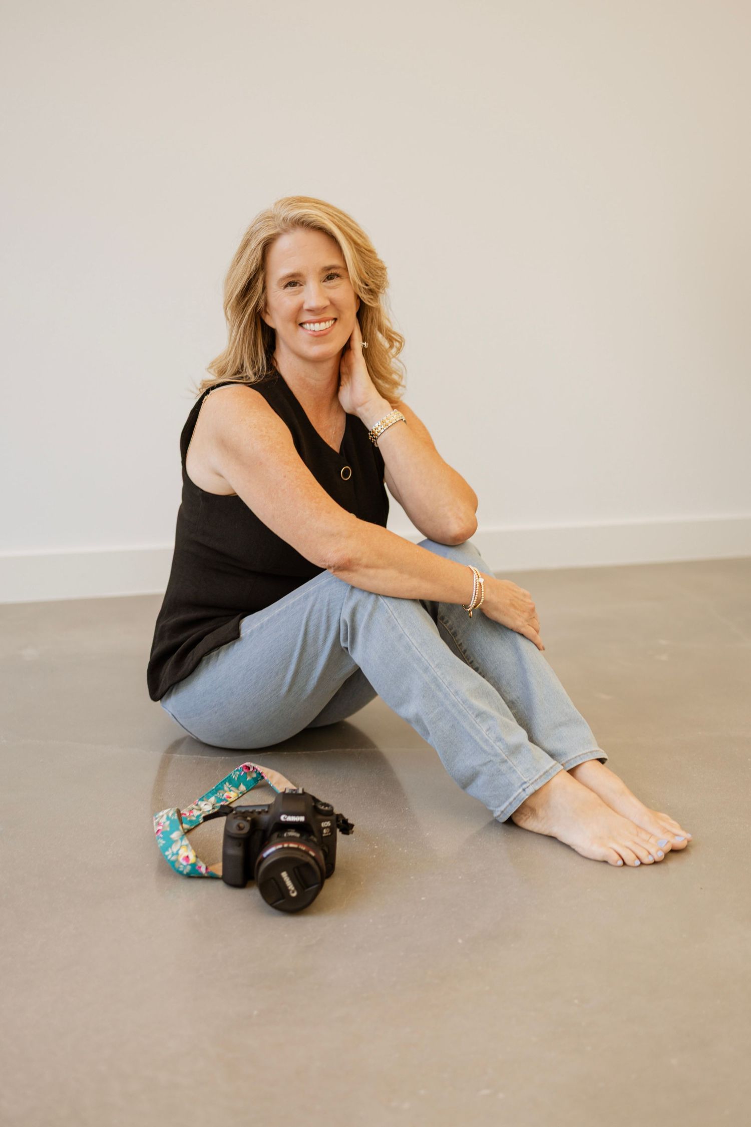 Photographer Kim smiling beside her Canon camera