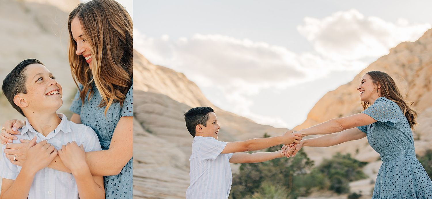 Mother and young son laughing and holding hands together outdoors in a sunny desert setting.