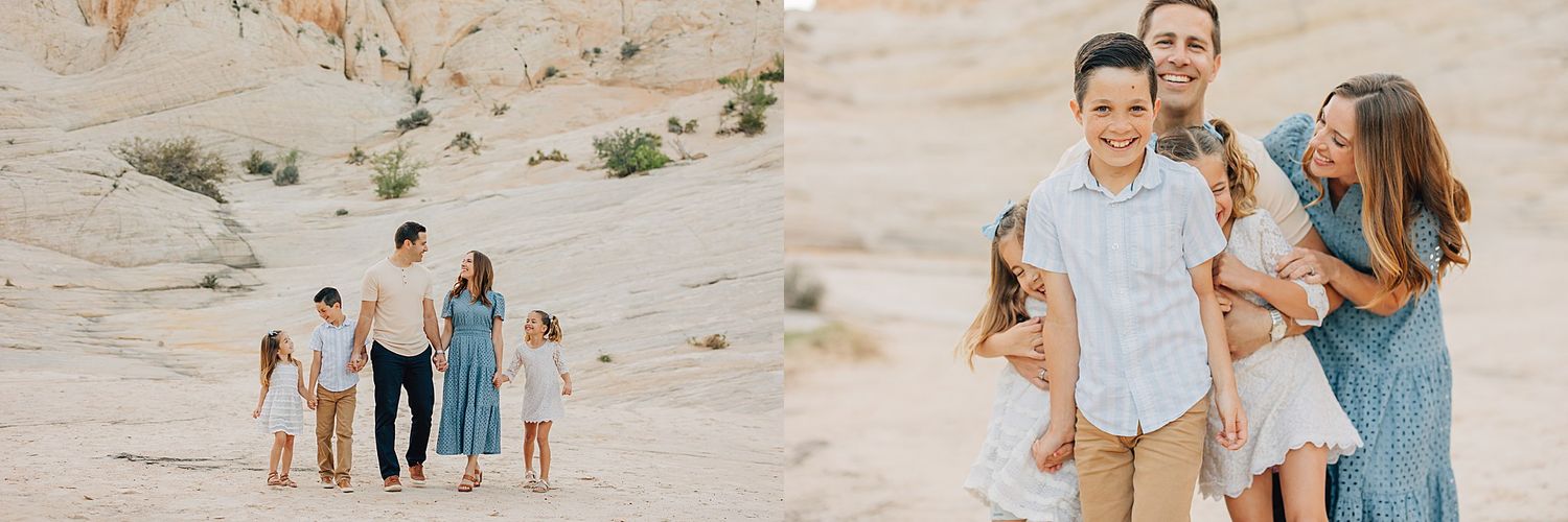 A family walks and poses together in a sandy desert landscape, wearing coordinated blue and white outfits.