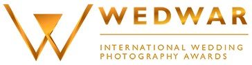 Gold and white Wedwar International Wedding Photography Awards logo with triangular emblem.