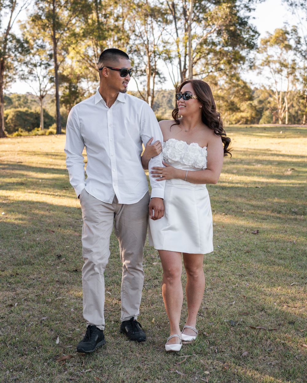 elopement photoshoot in western sydney parklands, couple looking at each other and walking towards the camera