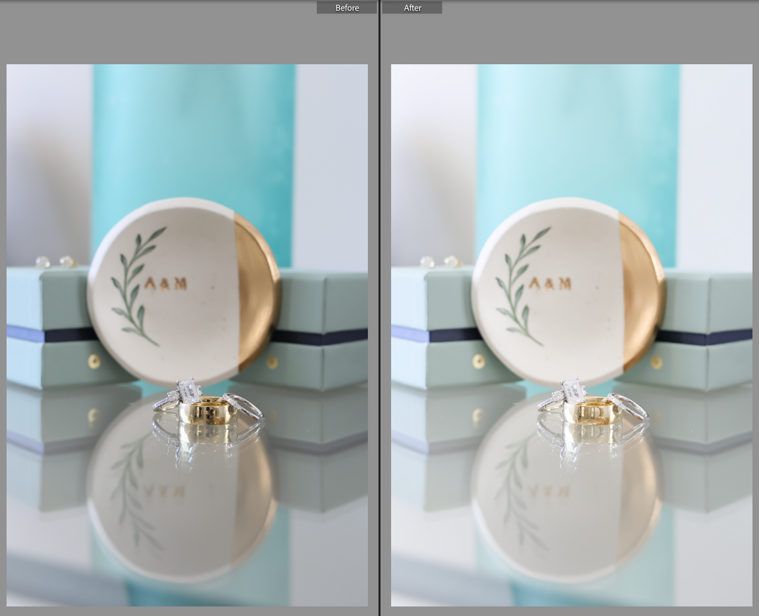 Gold ring on a reflective surface next to a decorative ceramic plate with leaf designs.