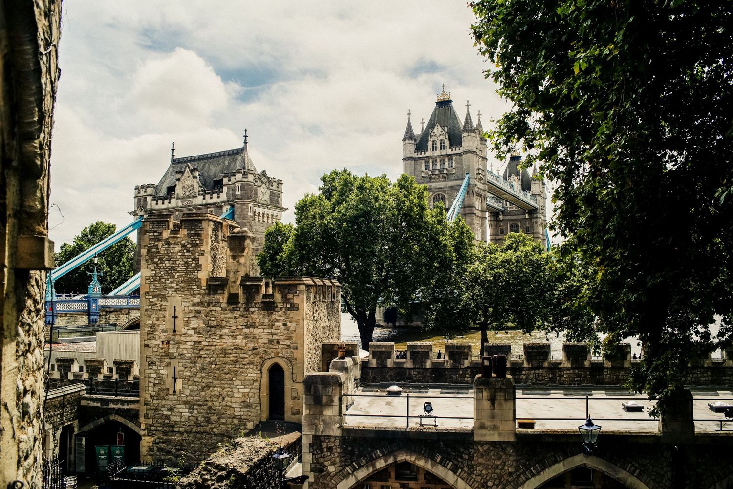 Tower Bridge crosses the River Thames with Gothic architecture and stone towers in London.