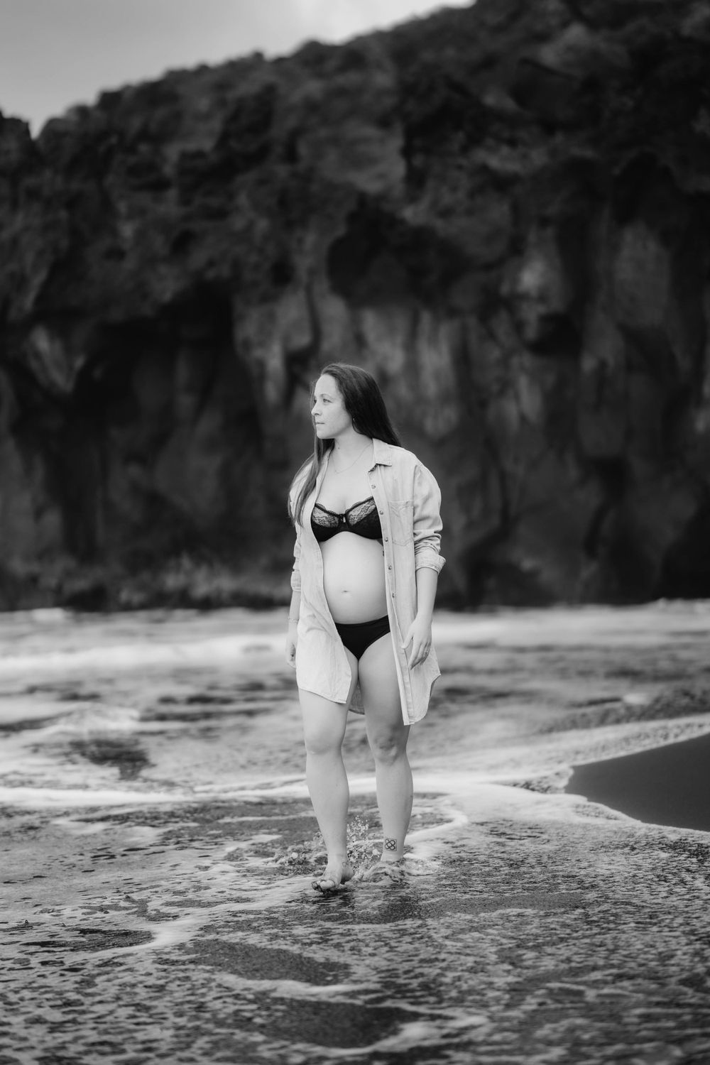 A serene maternity photoshoot at Playa Bollullo, Tenerife, Canary Islands. Celebrating the beauty of motherhood by the ocean's waves.