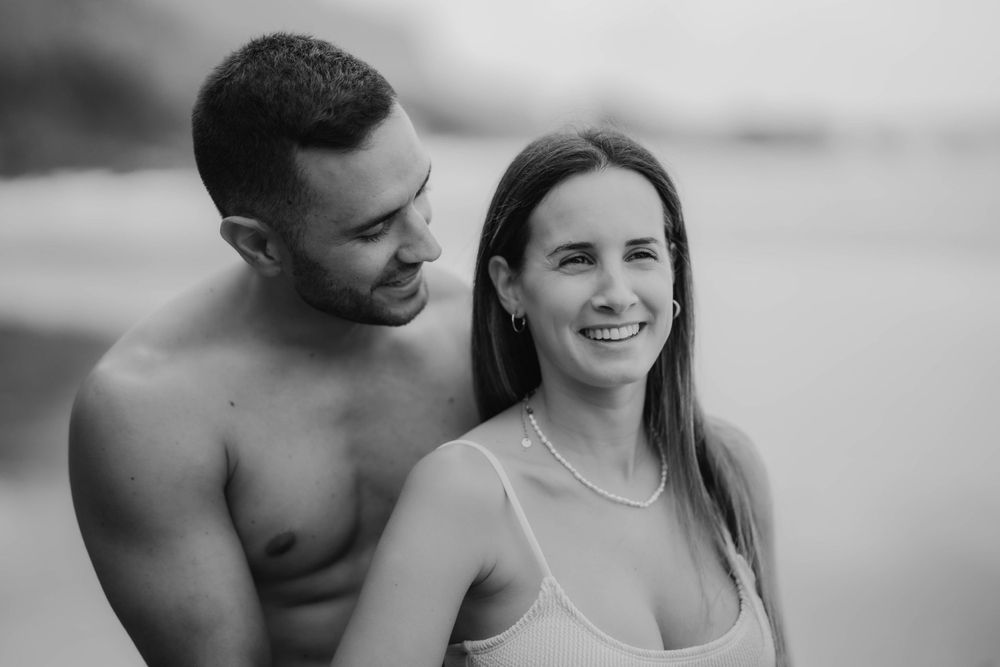 A serene maternity photoshoot at Playa Bollullo, Tenerife, Canary Islands. Celebrating the beauty of motherhood by the ocean's waves.