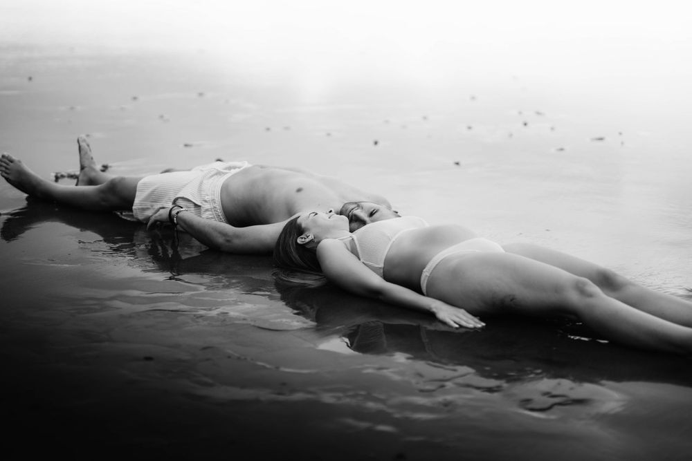 A serene maternity photoshoot at Playa Bollullo, Tenerife, Canary Islands. Celebrating the beauty of motherhood by the ocean's waves.