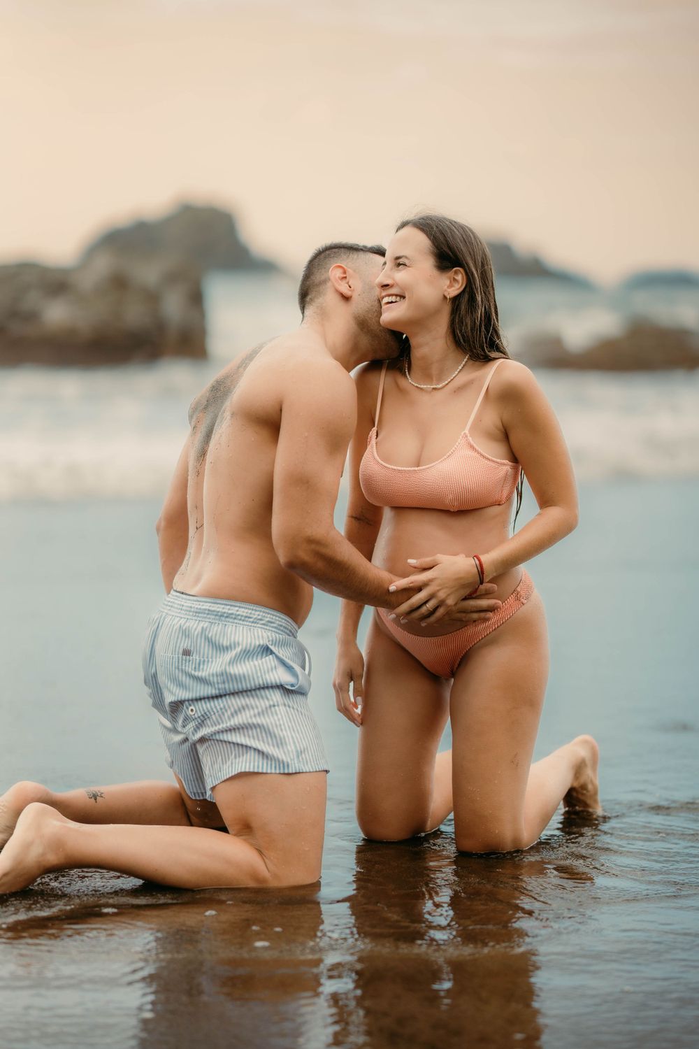 A serene maternity photoshoot at Playa Bollullo, Tenerife, Canary Islands. Celebrating the beauty of motherhood by the ocean's waves.