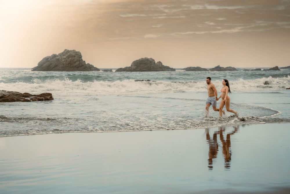 A serene maternity photoshoot at Playa Bollullo, Tenerife, Canary Islands. Celebrating the beauty of motherhood by the ocean's waves.