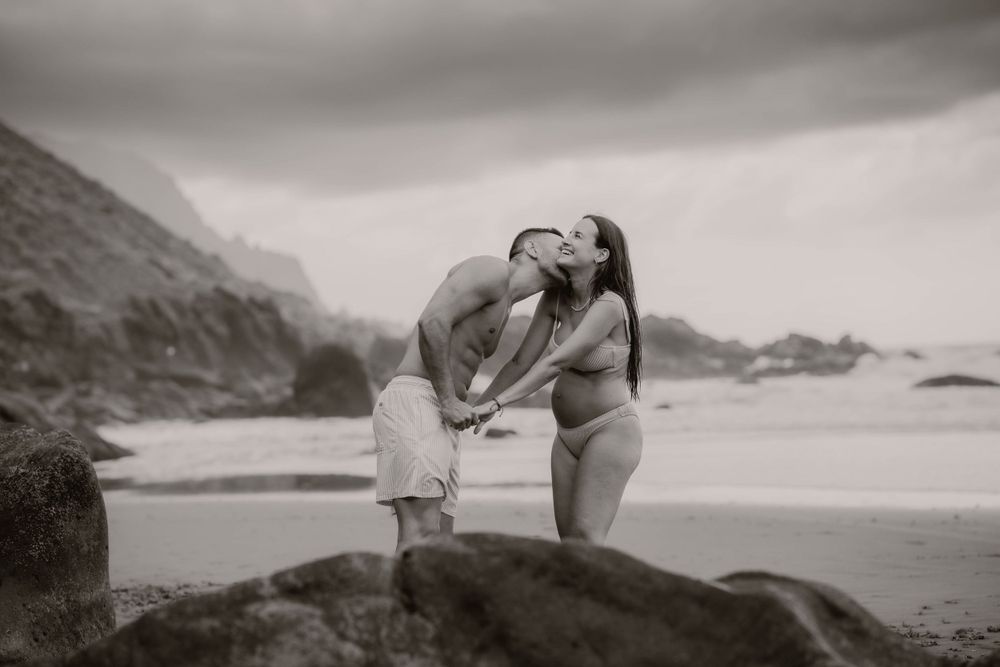 A serene maternity photoshoot at Playa Bollullo, Tenerife, Canary Islands. Celebrating the beauty of motherhood by the ocean's waves.