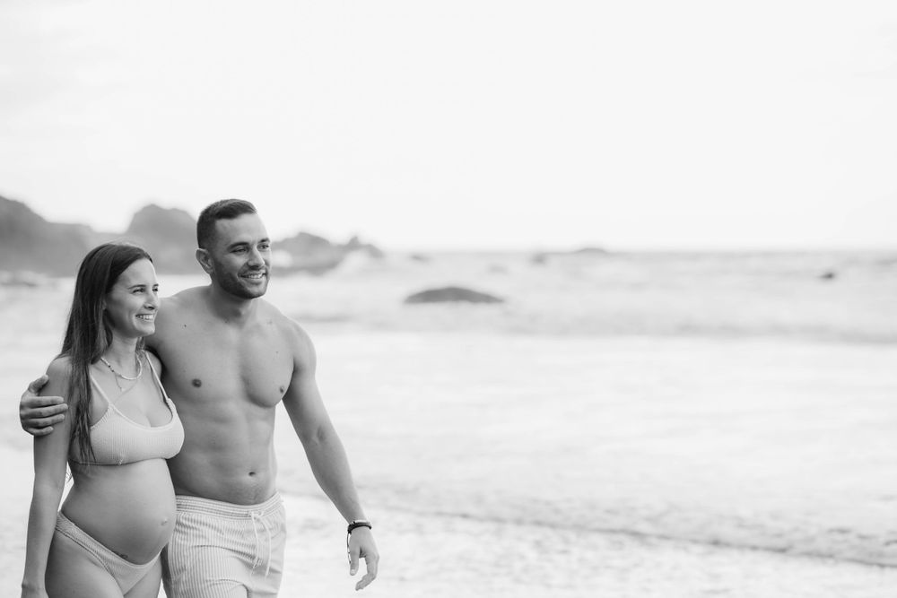 A serene maternity photoshoot at Playa Bollullo, Tenerife, Canary Islands. Celebrating the beauty of motherhood by the ocean's waves.