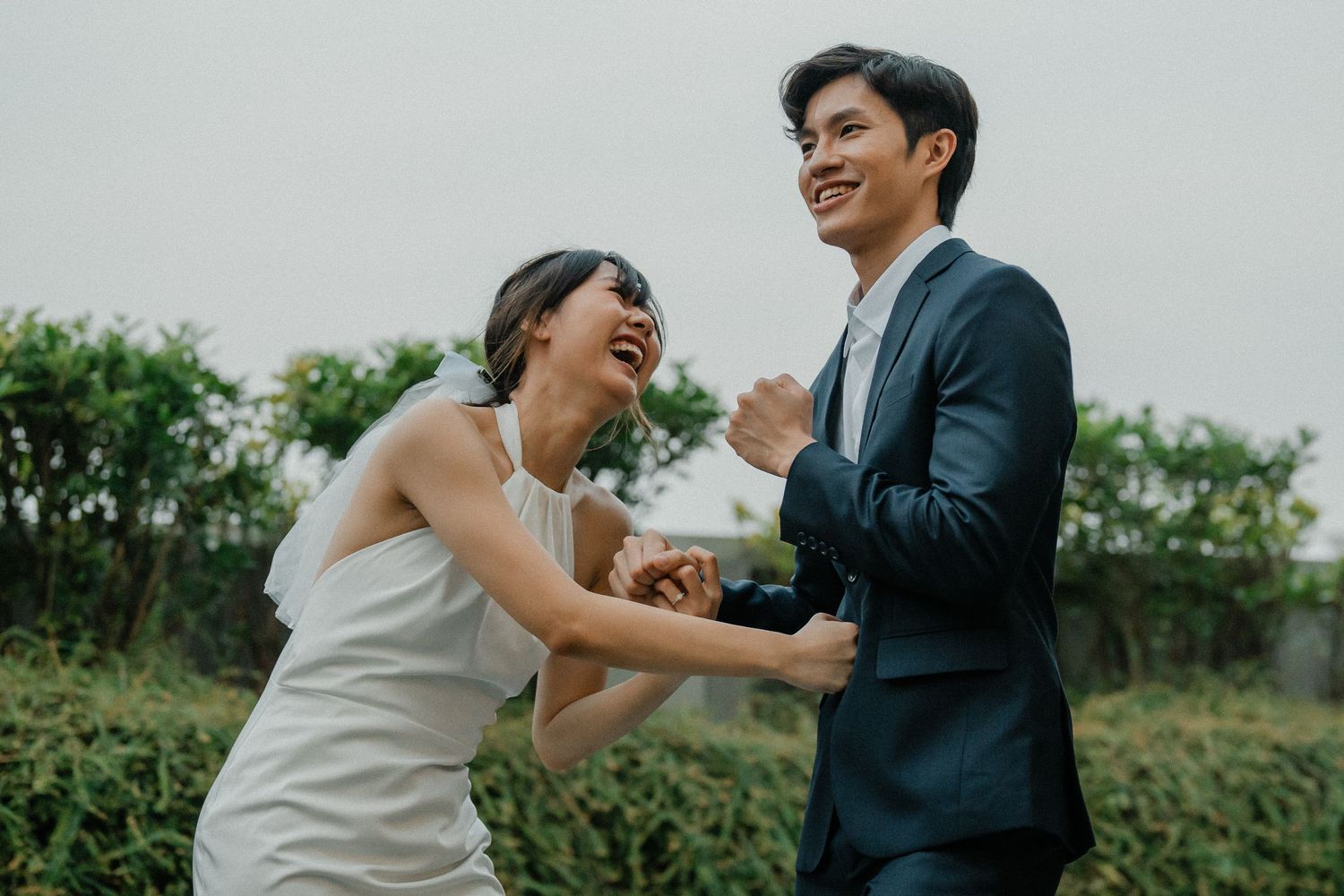 A candid shot of a couple sharing genuine laughter during their wedding photography session.