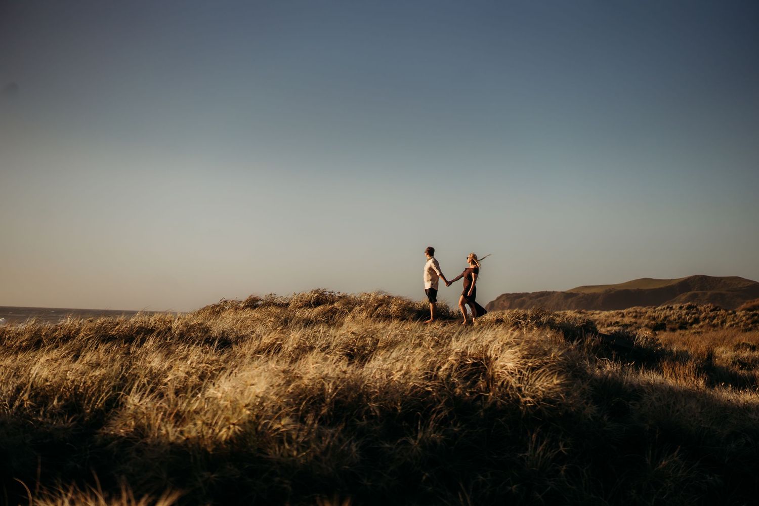 landscape-photo-at-beach-with-engaged-couple-holding-hands