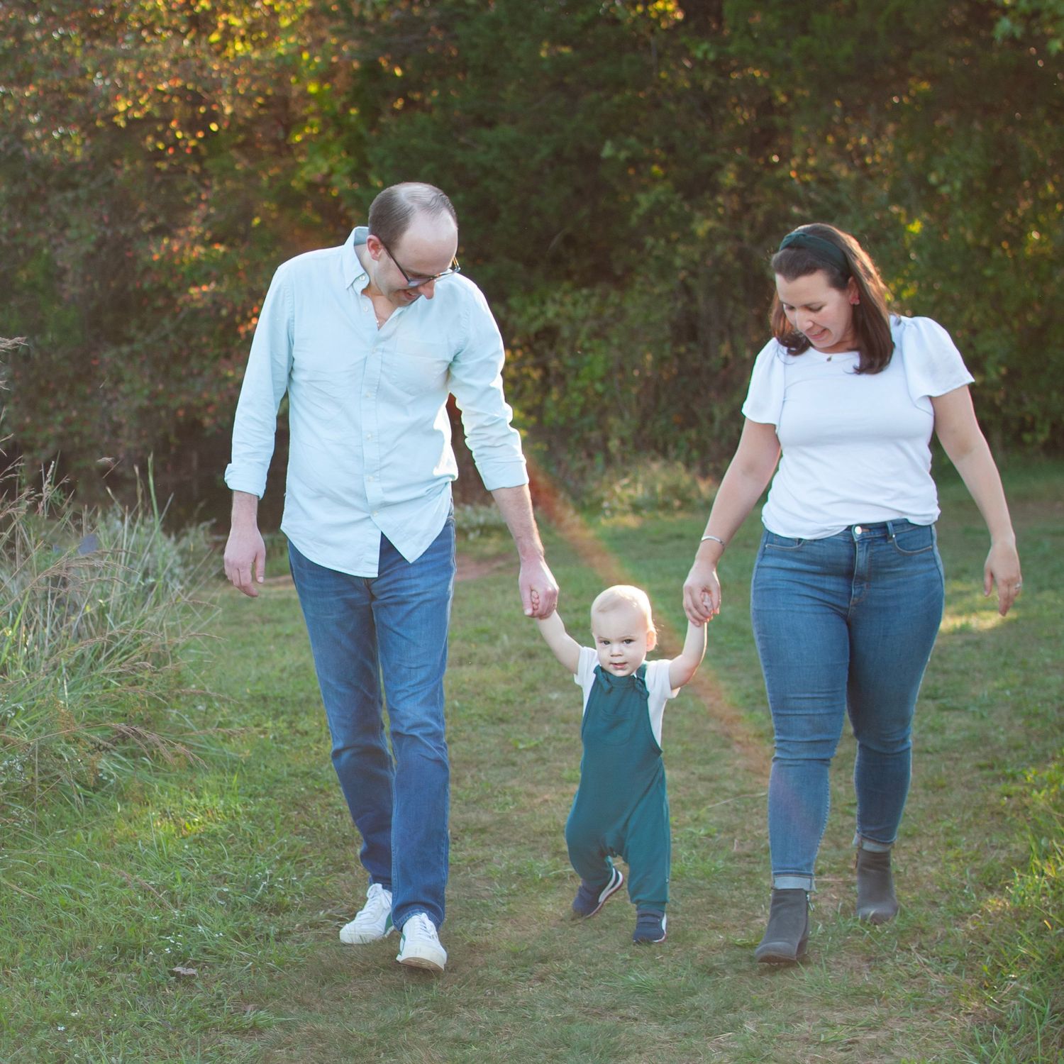 candid photo of family with toddler walking