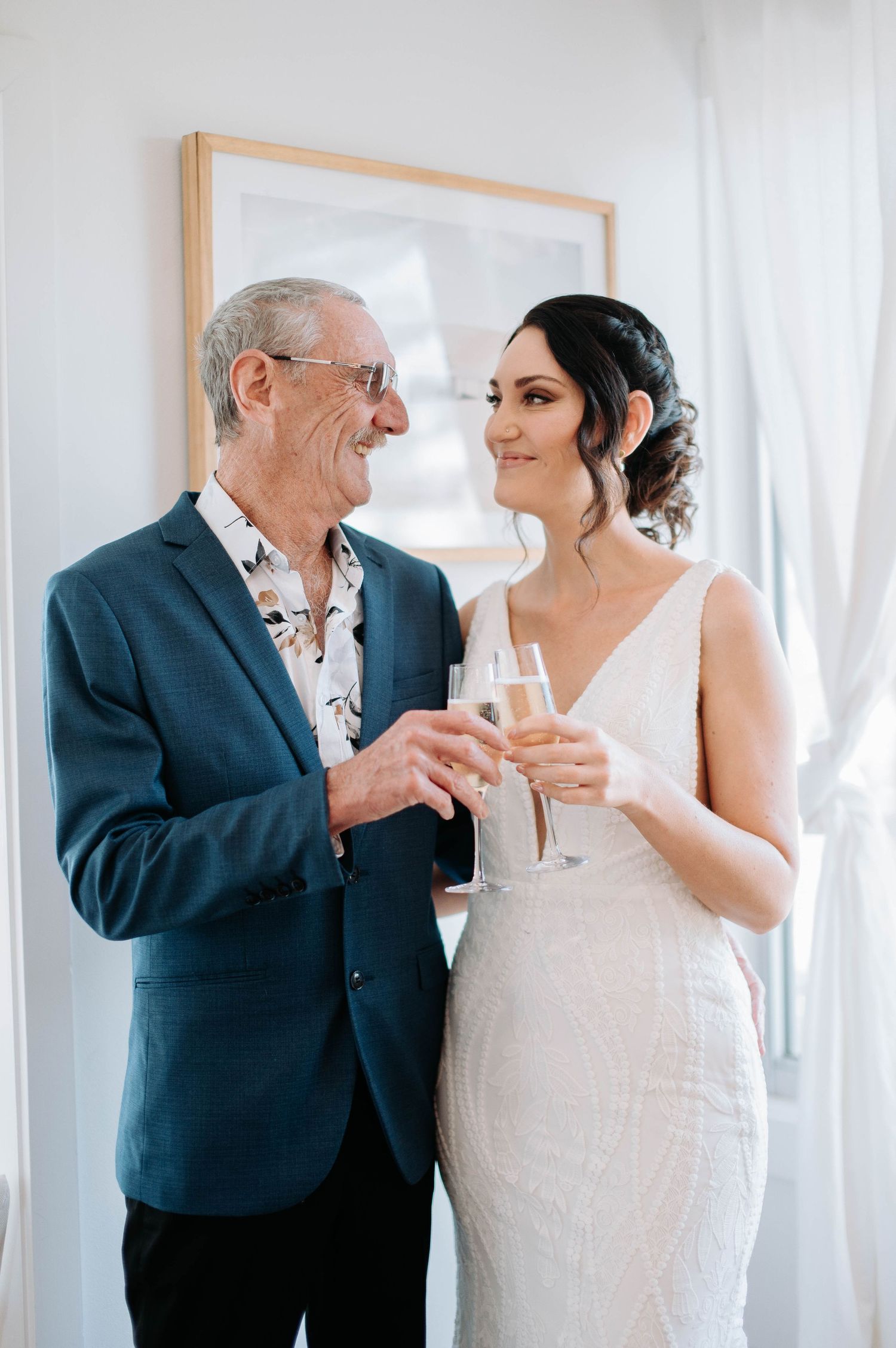 Elegant indoor wedding scene with champagne toast.