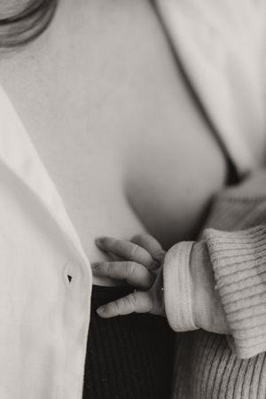 Close-up black and white image of hands grasping white fabric.