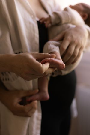 Gentle hands holding and caressing in soft natural light.