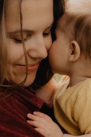 Tender close-up sequence showing loving moments in warm tones.