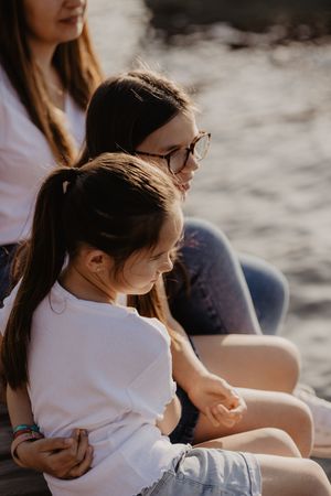 Candid outdoor photographs of people sitting together in warm sunset lighting.