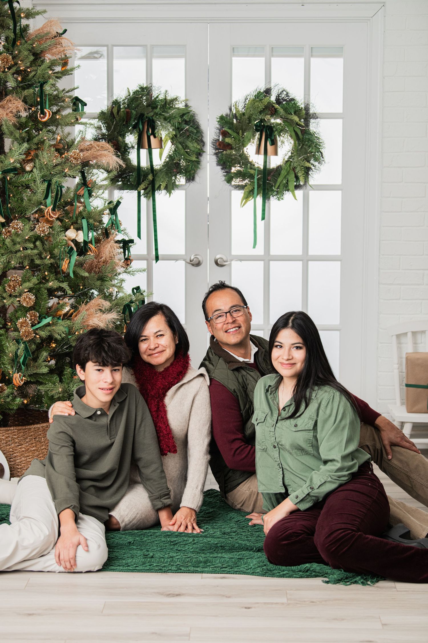 Family gathered together for a holiday photo session at the studio, capturing a joyful and memorable moment of togetherness.