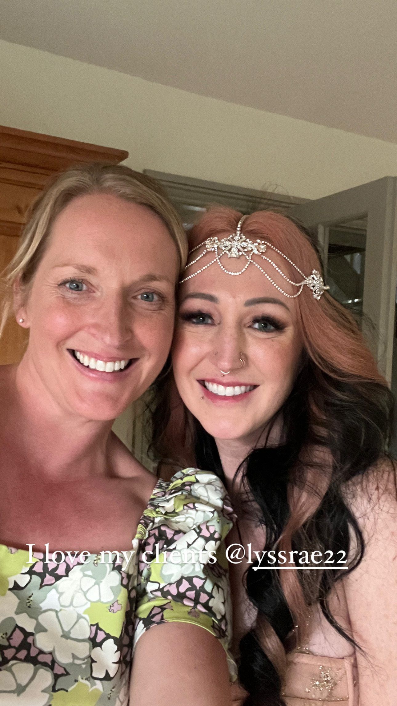 A selfie photo of a Nova Scotia wedding photographer and bride wearing floral prints, one with a delicate silver headpiece.
