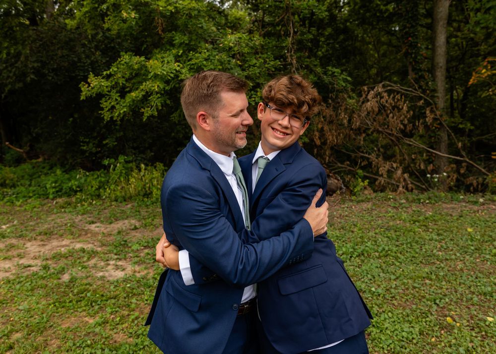 Groom & son at backyard garden wedding in Omaha, Nebraska. - BrightSide Photography