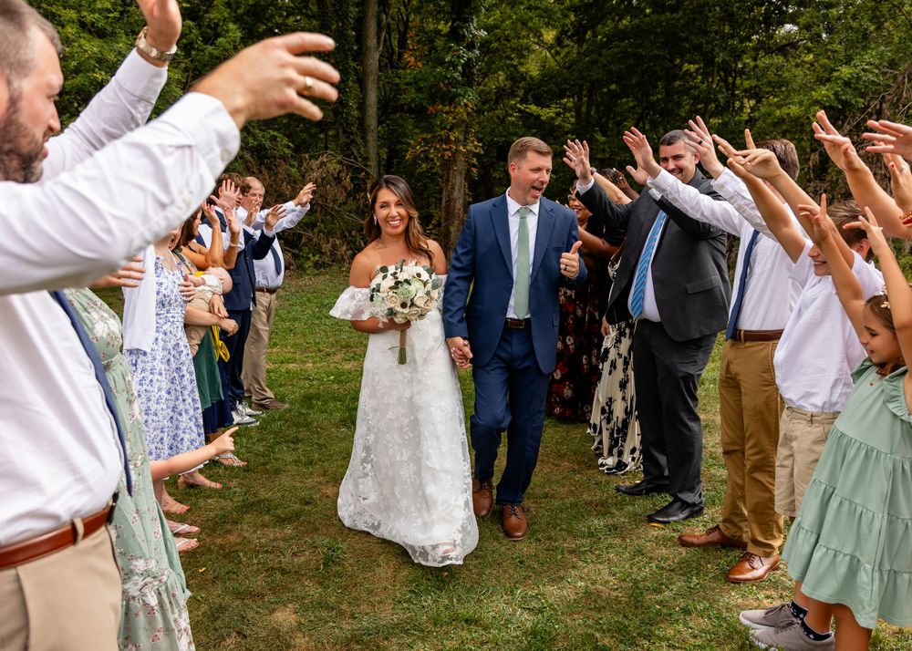 Wedding Couple walk at their beautiful storybook backyard wedding in Omaha, Nebraska. - BrightSide Photography