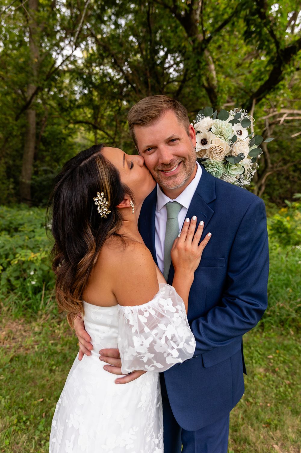 Bride & groom kiss at their beautiful backyard wedding in Omaha, Nebraska. - BrightSide Photography