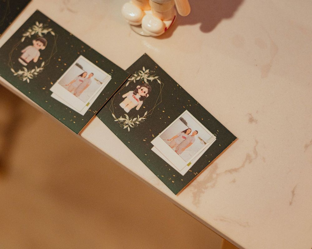 Vintage-style photo cards and decorative frames arranged on a beige surface with soft lighting.