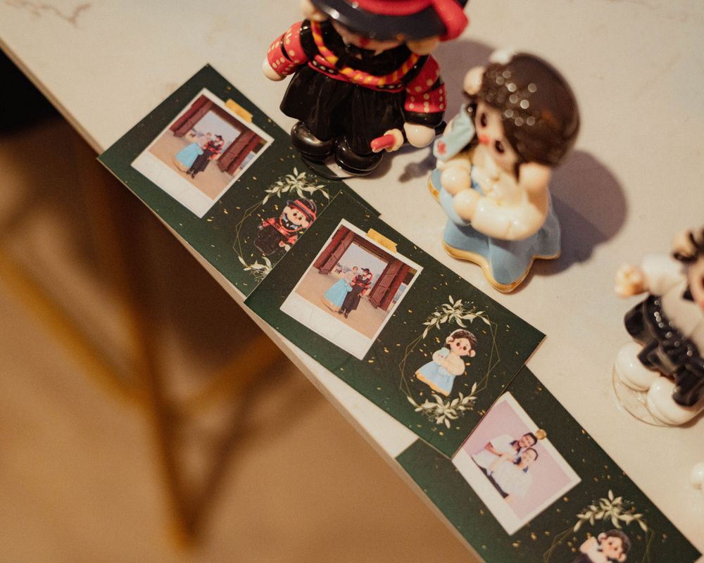 Decorative photo cards displayed with small figurines in a nostalgic setup.