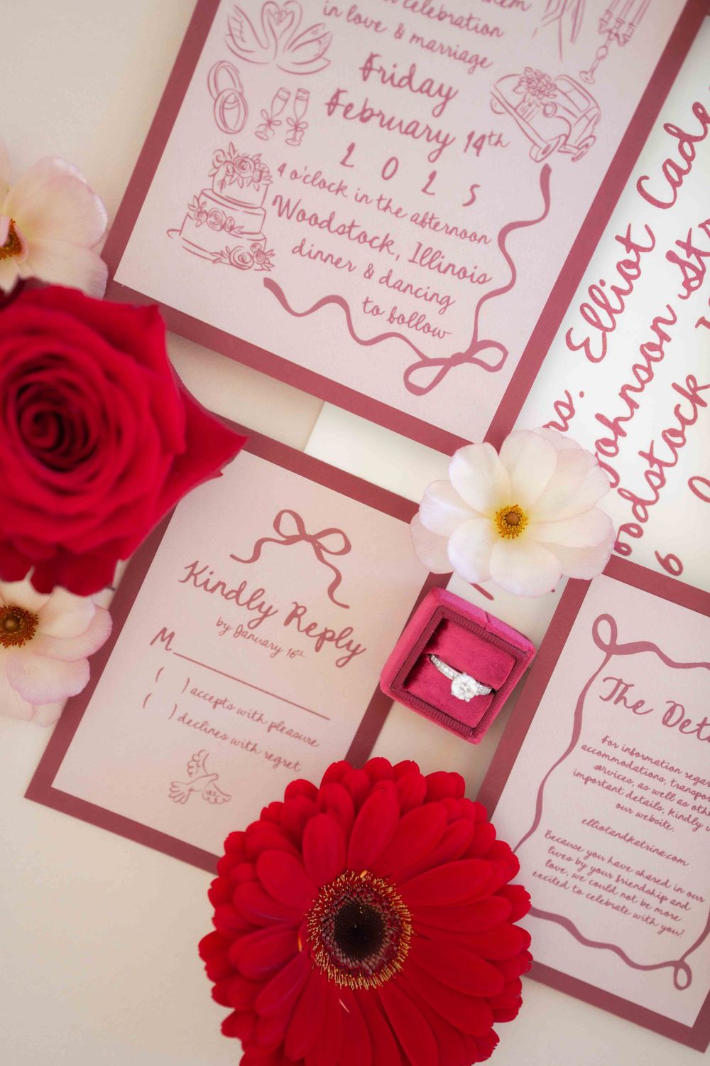 Wedding stationery layout featuring red roses, white flowers, and pink response cards. Location: Courthouse Square Woodstock, IL.