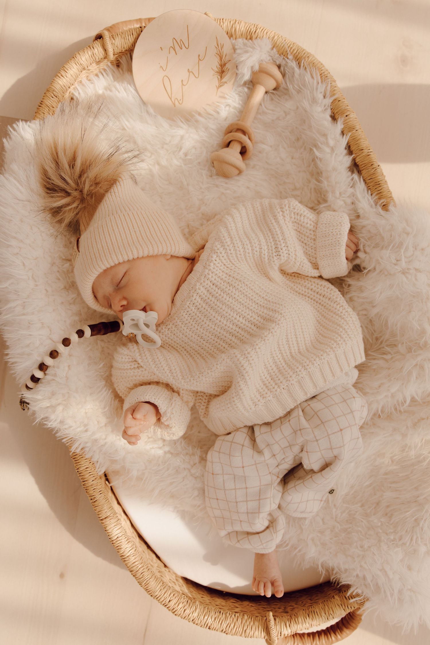 Newborn baby sleeping peacefully on a soft blanket, captured in a cozy indoor photoshoot