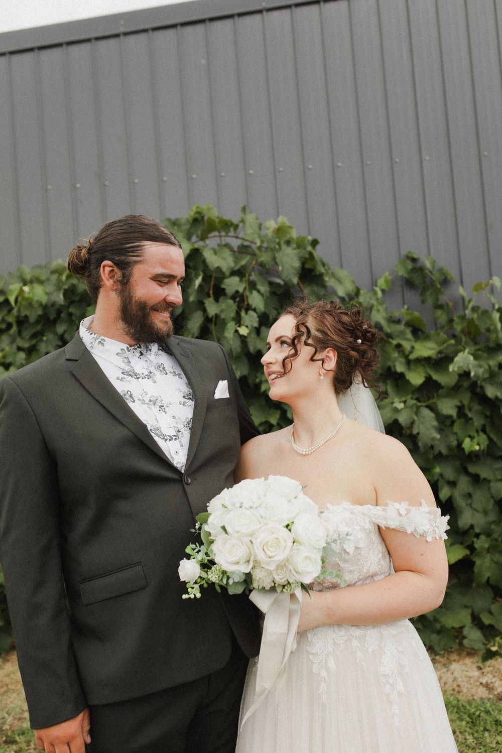 Bride and groom posing for portrait at private Morrinsville farm wedding