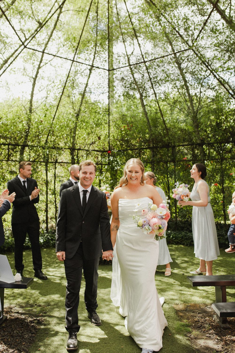 Couple walking down aisle at TreeChurch and Gardens