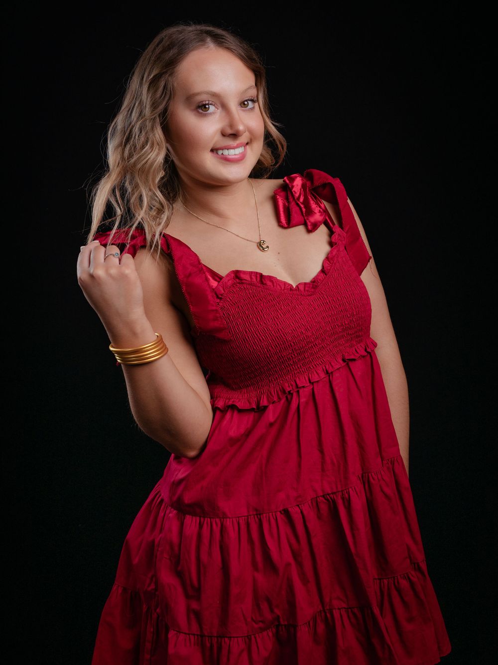 Photo of high school senior girl in red dress photographed by senior portrait photographer in Jefferson County TN