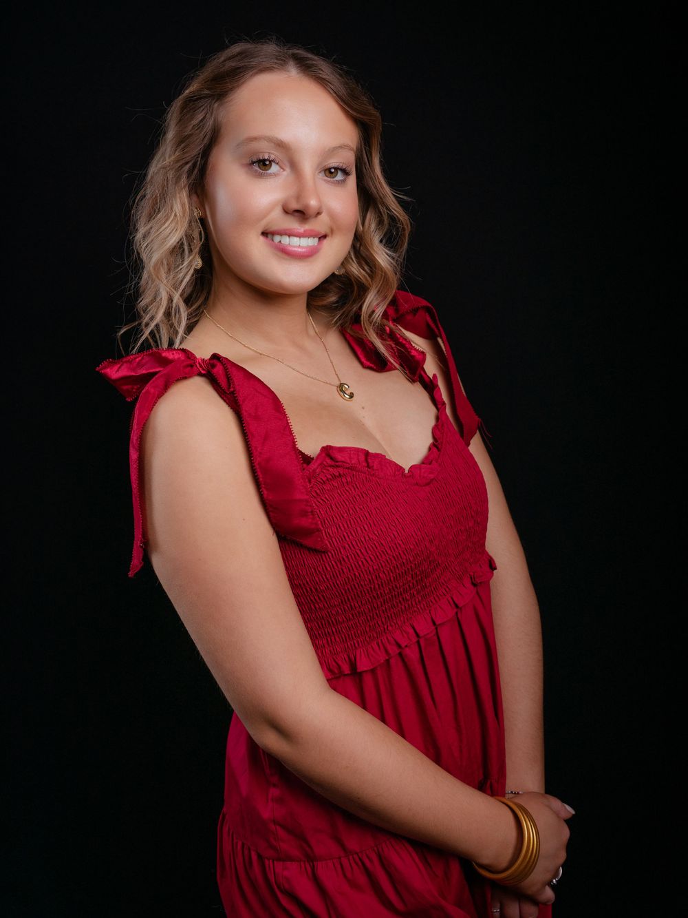 Photo of high school senior girl in red dress photographed by senior portrait photographer in Jefferson County TN