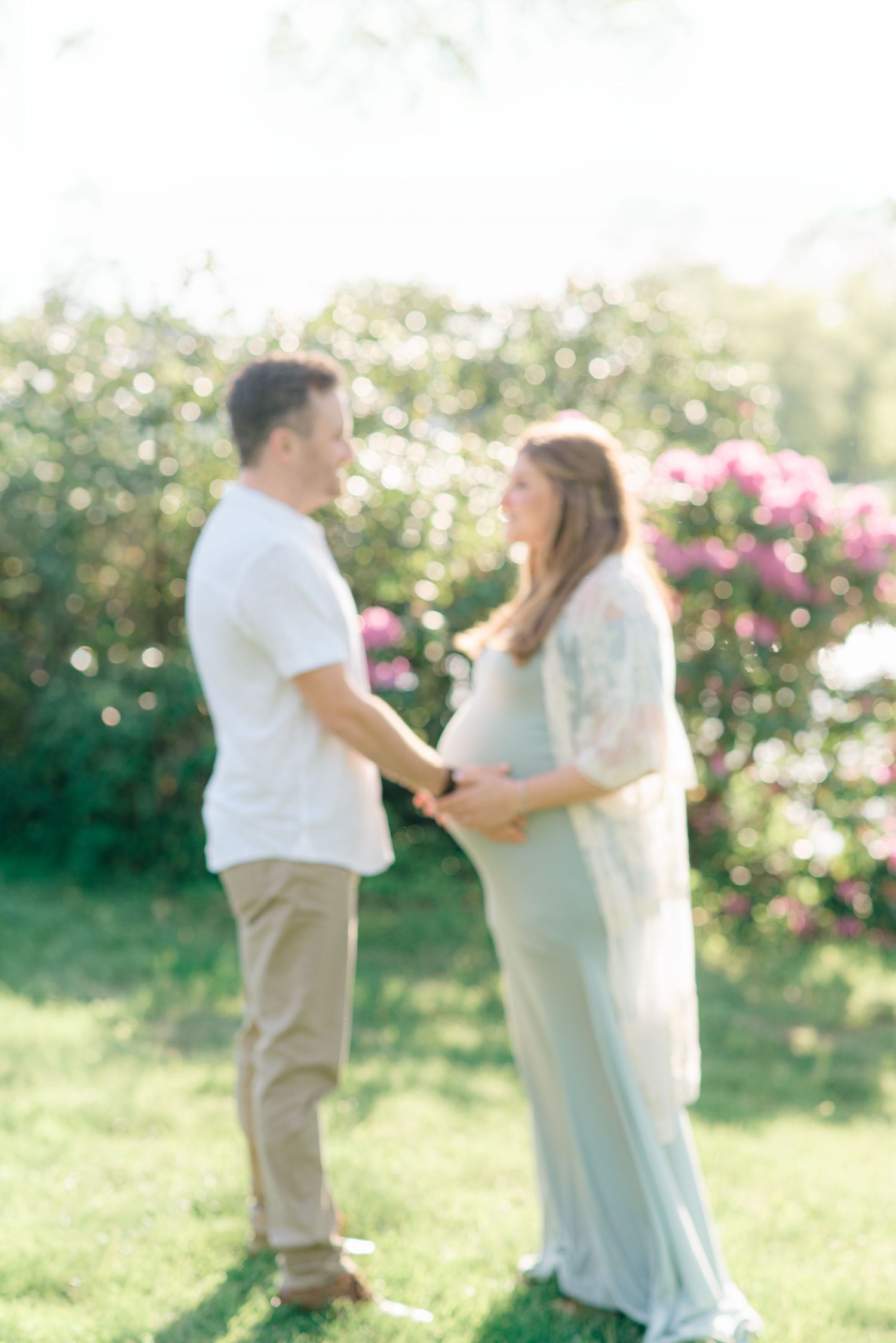 A couple holds hands while looking into each other's eyes.
